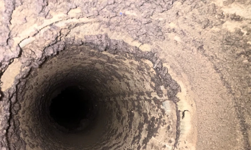 Close-up of lint buildup inside a dryer vent duct before professional cleaning in St. Augustine, FL